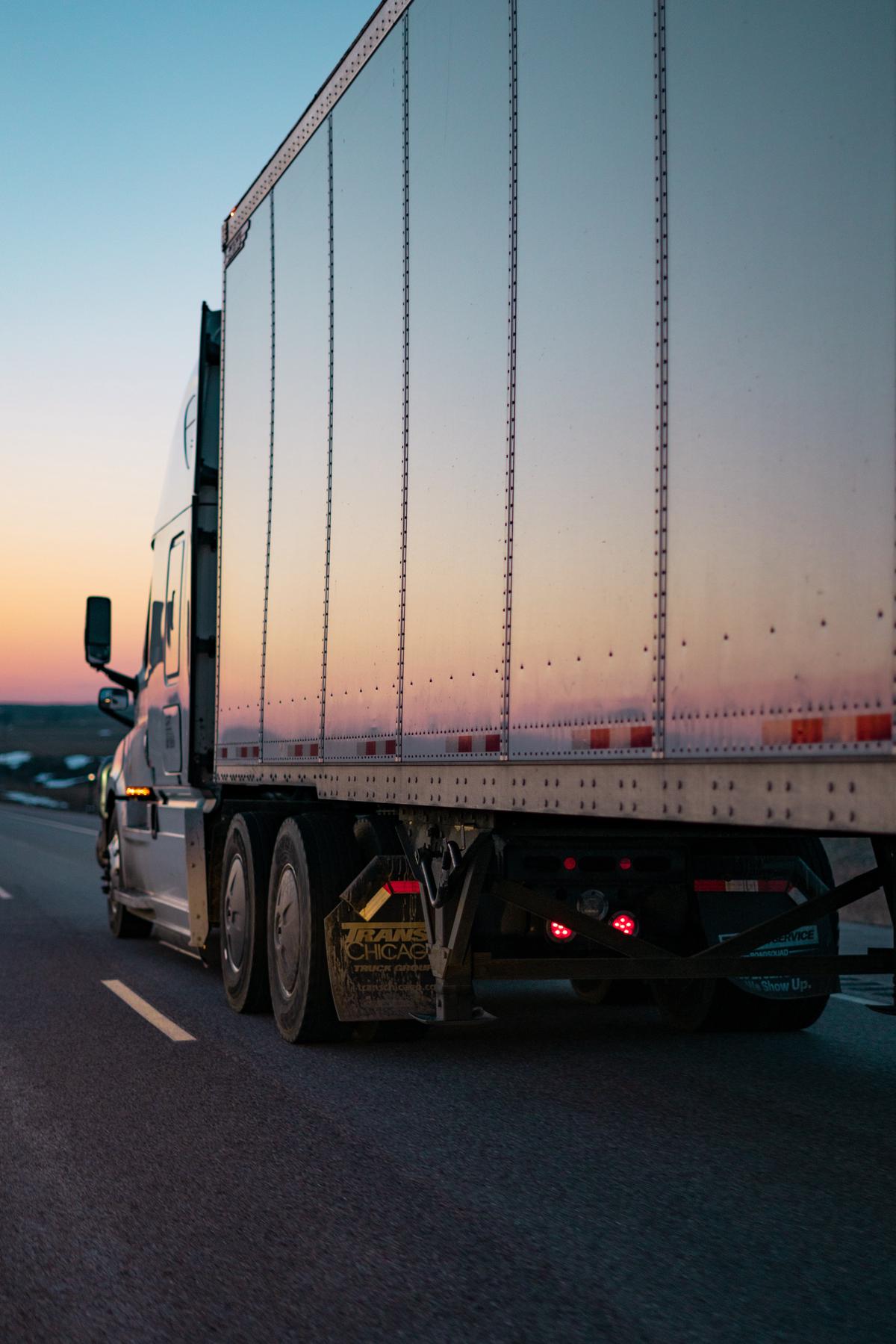 An image showing a commercial moving truck with technology-related icons surrounding it, representing the technological advancements in the industry.