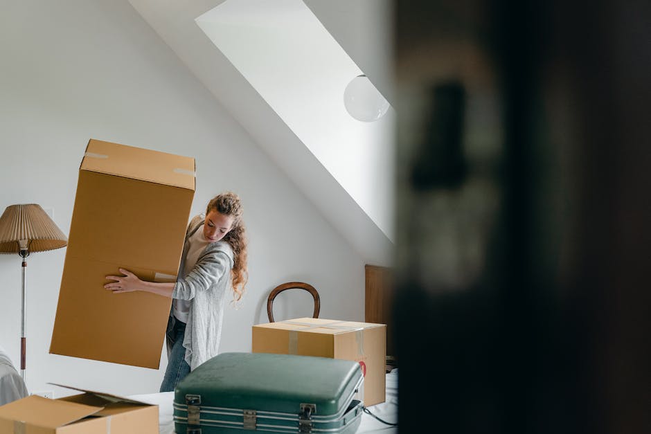 A group of people moving furniture into a new home.