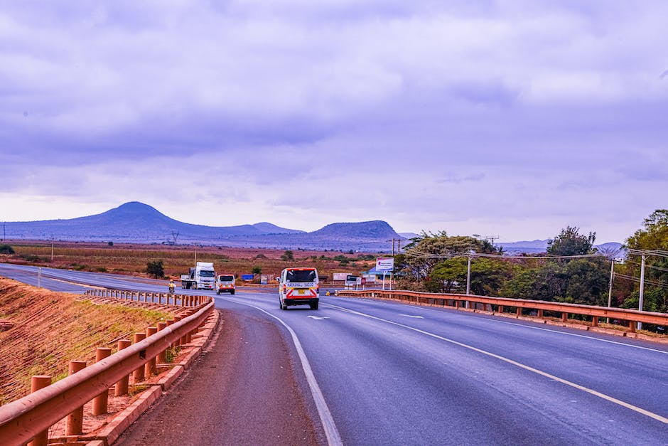 An image of a cross-country moving truck on a highway