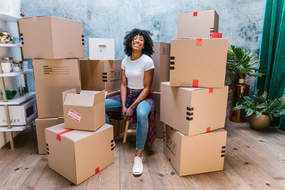 An image showing employees packing boxes and moving furniture during a relocation process.