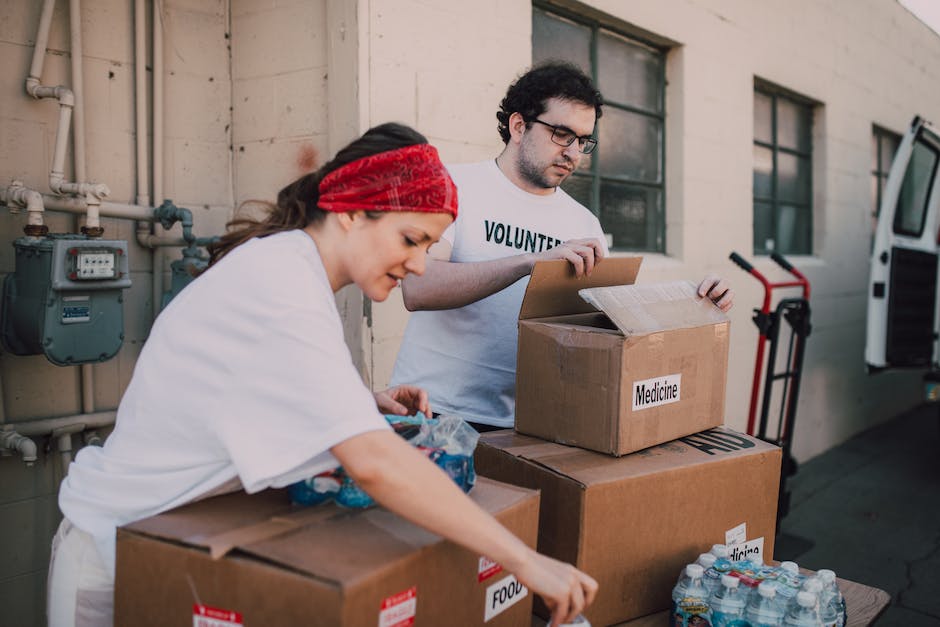 Image illustrating a moving company packing boxes and loading them onto a truck.