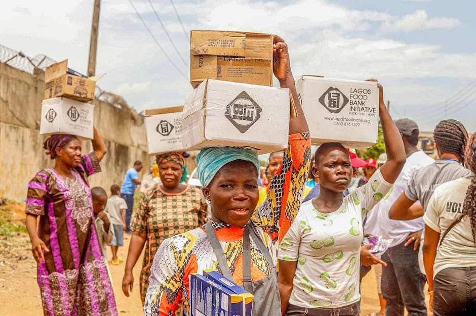 A group of people carrying boxes and furniture during a move