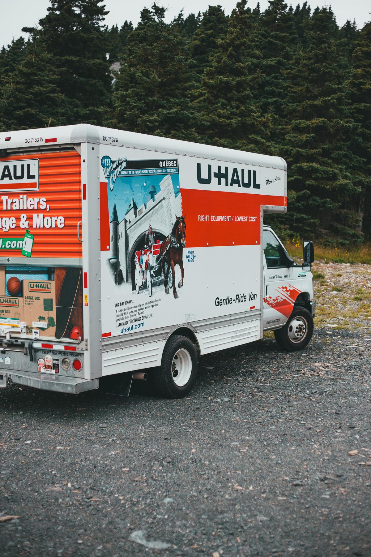 A moving truck parked in front of a New York City apartment building