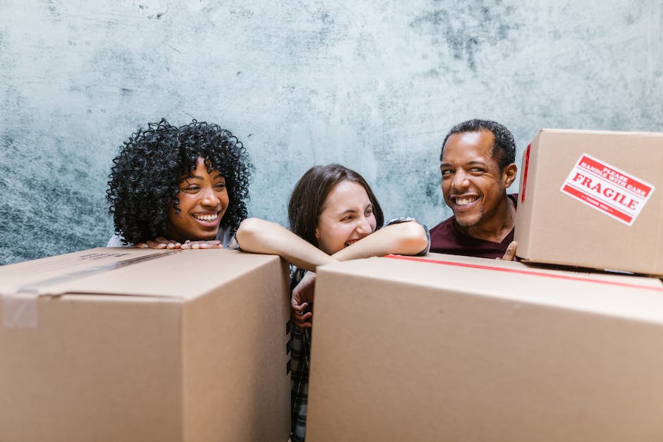 Professional movers standing together with eco-friendly materials and renewable energy sources, representing their commitment to sustainability.