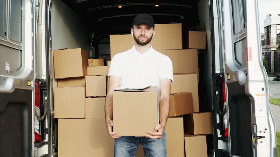 Image of a residential moving service truck and workers assisting with moving boxes, representing the text about emerging trends in the residential moving services market