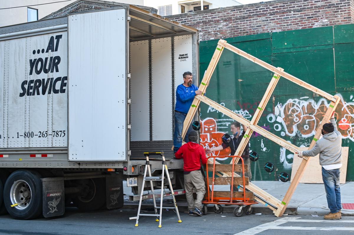 A group of movers packing boxes and loading them onto a truck, representing the Texas moving industry's innovation and adaptability